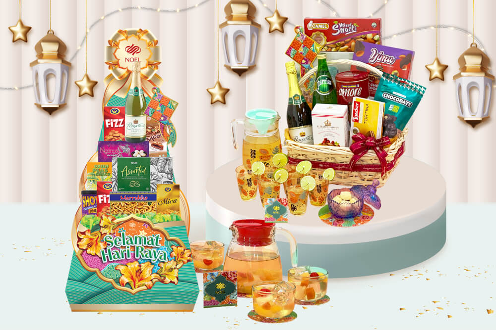 Left: A festive Hari Raya hamper featuring a variety of snacks and drinks such as biscuits, chocolates, and sparkling juice, accompanied by a pitcher and glasses. 

Right: A Hari Raya gift basket filled with an assortment of treats including Camel Mixed Snacks, Yimu Chocolate Cookies, and Chocodate, alongside beverages such as sparkling juice and Perrier water. It also features a pitcher and glasses.