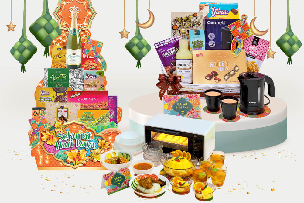 Left: A Hari Raya hamper featuring a bottle of sparkling drink and an assortment of cookies and snacks, a modern toaster oven, and a full spread including dishes of food and glasses of drinks.

Right: A Hari Raya festive gift basket showcasing a variety of products, including Yimu cookies, Bickford's diet lemon juice, Millennium Golden Nuts, a Cornell travel kettle, and a packet of Peanut Crackers.