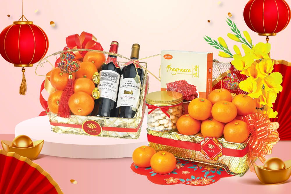 A Chinese New Year gift basket packed with oranges, barbecue pork slices and a bottle of Kuih Bangkit. A Chinese New Year gift basket packed with 2 bottles of wine and 8 pieces of mandarin oranges.